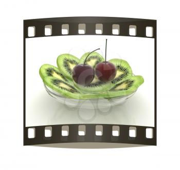 slices of kiwi and cherry on a white. The film strip