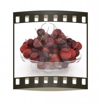 Sweet cherries on a plate on a white background. The film strip