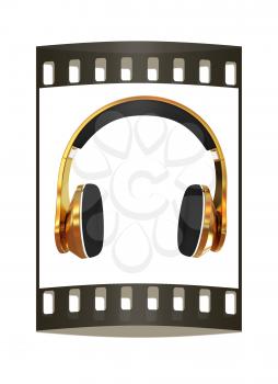 Golden headphones on a white background. The film strip