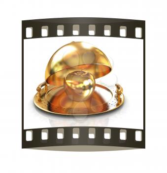 Golden Apple on glossy golden salver dish under a golden cover on a white background. The film strip
