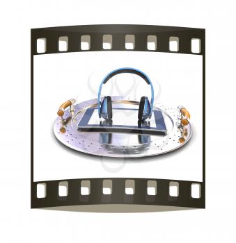 Phone and headphones on metal tray on a white background. The film strip