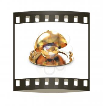 Earth globe on glossy golden salver dish under a golden cover on a white background. The film strip