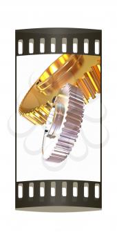 Gold gear set on a white background. The film strip
