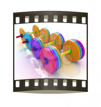 Colorful dumbbells on a white background. The film strip