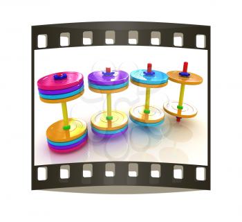 Colorful dumbbells on a white background. The film strip