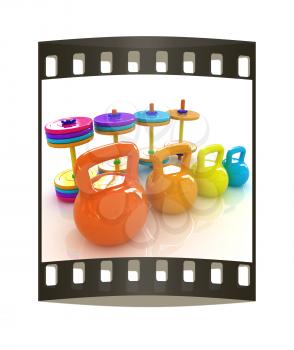 Colorful weights and dumbbells on a white background. The film strip