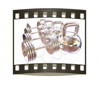 Metal weights and dumbbells on a white background. The film strip