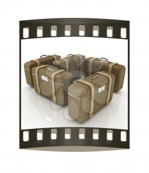 Brown traveler's suitcases on a white background. The film strip