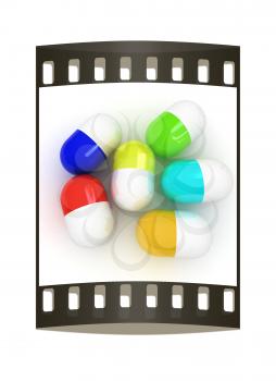 Pills on a white background. The film strip