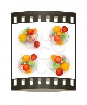 Set of citrus on a glass plate on a white. The film strip