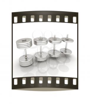 Metalll dumbbells on a white background. The film strip