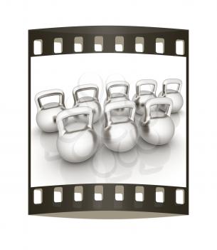 Metall weights on a white background. The film strip