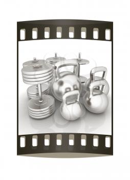 Metall weights and dumbbells on a white background. The film strip