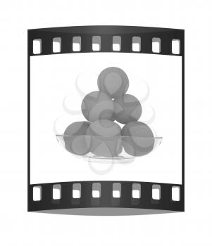 Oranges on a glass plate on a white background. The film strip