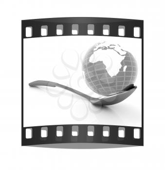 Blue earth on gold spoon on a white background. The film strip