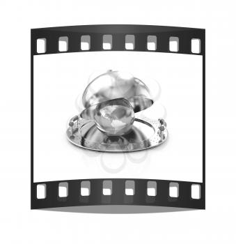 Earth globe on glossy salver dish under a cover on a white background. The film strip