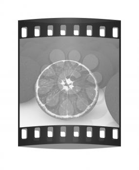 half oranges and oranges on a white background. The film strip