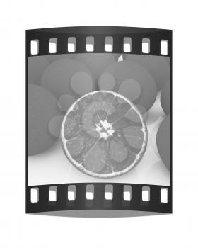 half oranges and oranges on a white background. The film strip