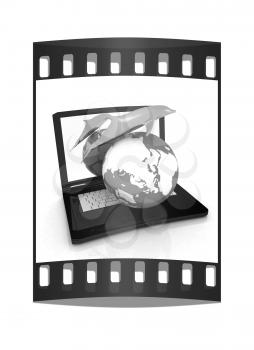 Golden Dolphin from the laptop. Global concept. The film strip