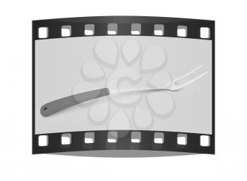 Large fork on light gray background. The film strip