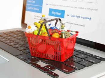 Shopping basket with variety of grocery products ion laptop keyboard. E-commerce concept 3d illustration