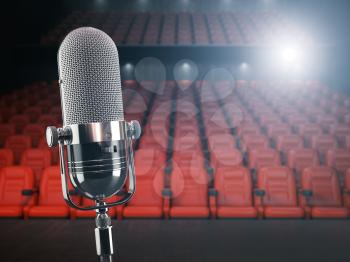 Vintage microphone on the stage of concert hall or theater with red seats and spot light. 3d illustration