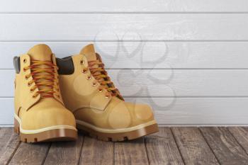 Yellow boots on a wooden table. 3d illustration
