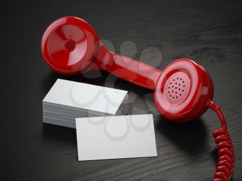 Mockup of  blank business cards and  red retro phone receiver  on  the black wooden desk background. 3d illustration