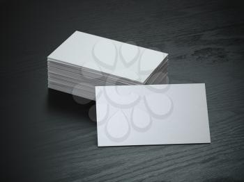 White blank business cards mockup on black wood table background, 3d illustration