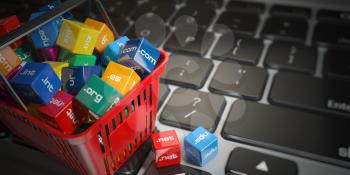 Shopping basket with domain nameson computer keyboard. Internet communication and e-business concept. 3d illustration