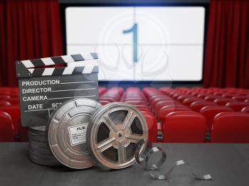 Cinema, movie or home video concept background. Film reels and clapper board in the theater movie cinema screen with empty seats. 3d illustration