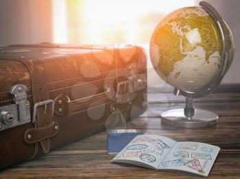 Travel or turism concept.  Old  suitcase  with open passport with visa stamps and globe. 3d illustration