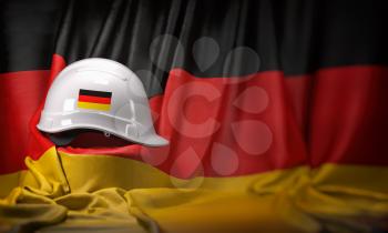 White hard hat laying over Germany flag. Construction and employment in Germanyconcept, . 3d illustration
