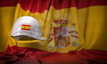 White hard hat laying over spanish  flag. Construction and employment in Spain concept,  3d illustration