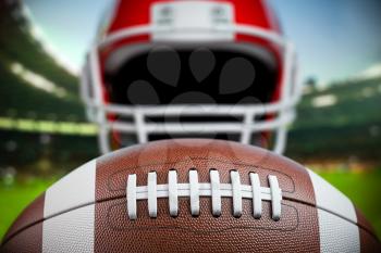 American football ball and helmet on the football arena or stadium. 3d illustration