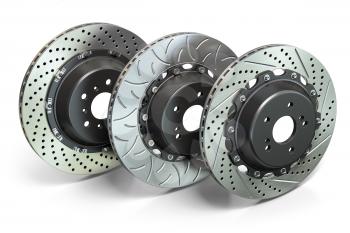  Drilled and slotted brake disks in a row. Different types of brake disks. 3d illustration