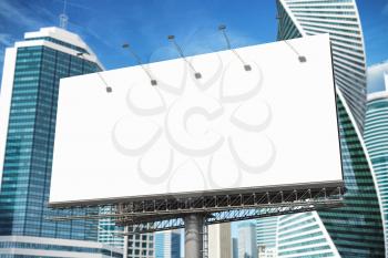 Blank billboard in the street of downtown city skyscrapers. 3d illustration
