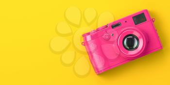Pink vintage photo camera on yellow background. 3d illustration