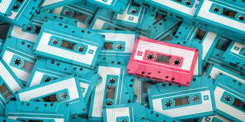 Vintage blue audio cassettes and one unique pink cassete. Creative retro concept of individuality. 3d illustration