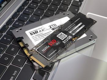 Different types of SSD disk drive isolated on laptop keyboard. Classic SSD and SSD m2. 3d illustration