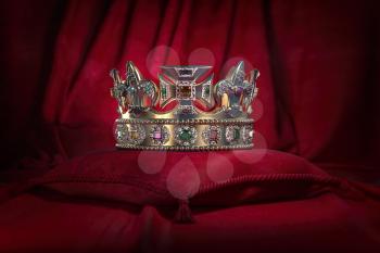 Golden crown on red velvet background Royal symbol, coronation. 3d illustration