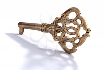 Vintage ornate brass key, isolated on white