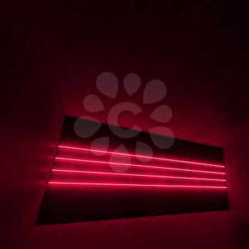 Abstract empty dark concrete interior with red neon light lines, square 3d illustration