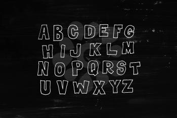 Hand drawn abc, doodle style. White letters over black chalkboard background, sketch illustration