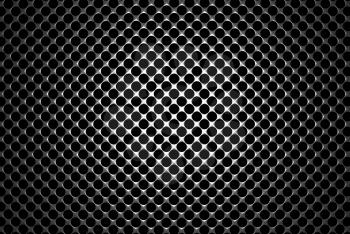 Steel grid with round holes and reflection on black background under the round central light, abstract textured background