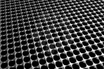 Steel grid with round holes and reflection on black background in diagonal perspective view