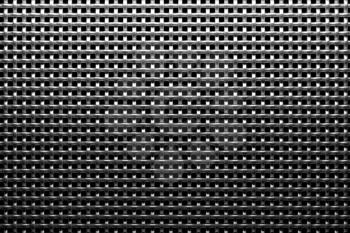 Braided wire steel grid with reflection on black background under the top straight light, abstract textured background