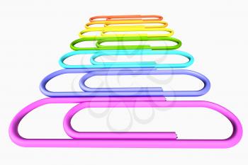 Colored paperclips laid out in a line isolated on white background close-up perspective view