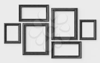 Black wooden blank picture or photo frames on white wall with shadows, decorative wooden picture frames template set, art frame mock-up 3D illustration