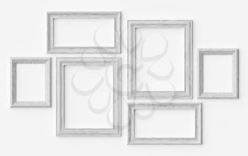 White wooden blank picture or photo frames on white wall with shadows, decorative wooden picture frames template set, art frame mock-up 3D illustration